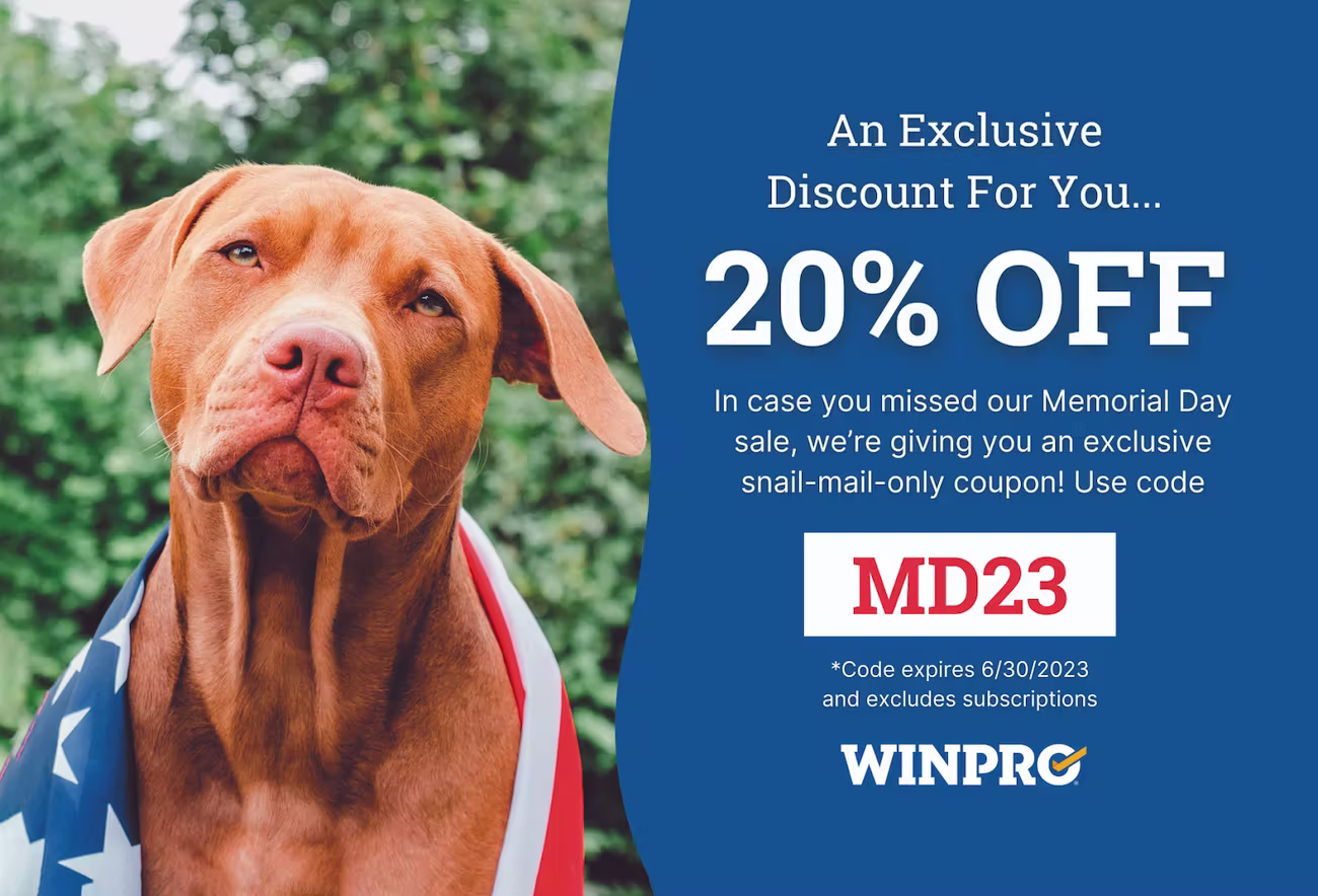 A patriotic-themed discount postcard featuring a brown dog draped in an American flag on the left and a bold offer on the right. Text reads: “An Exclusive Discount For You… 20% OFF. In case you missed our Memorial Day sale, we’re giving you an exclusive snail-mail-only coupon! Use code MD23.” WINPRO logo appears at the bottom with a note that the code expires 6/30/2023 and excludes subscriptions.