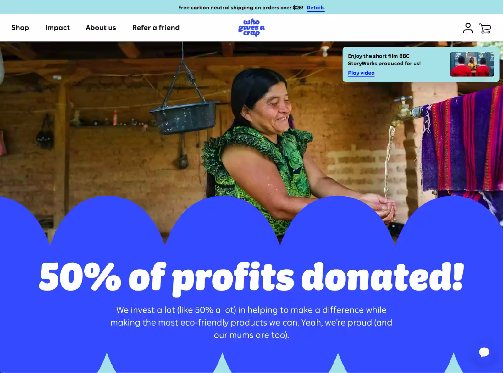 Smiling woman washes hands at an outdoor spigot; bold text over blue scallops reads “50% of profits donated!” with WGAC site nav at top.