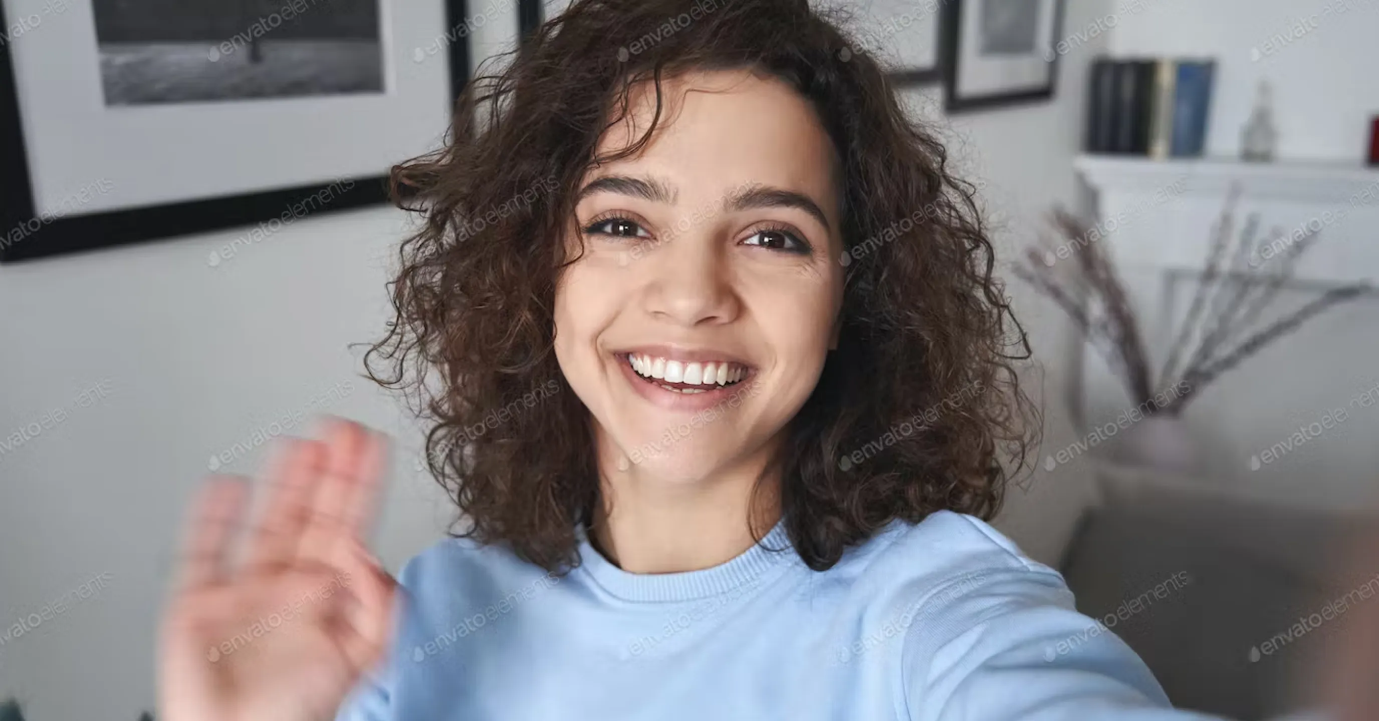 girl smiling and waving