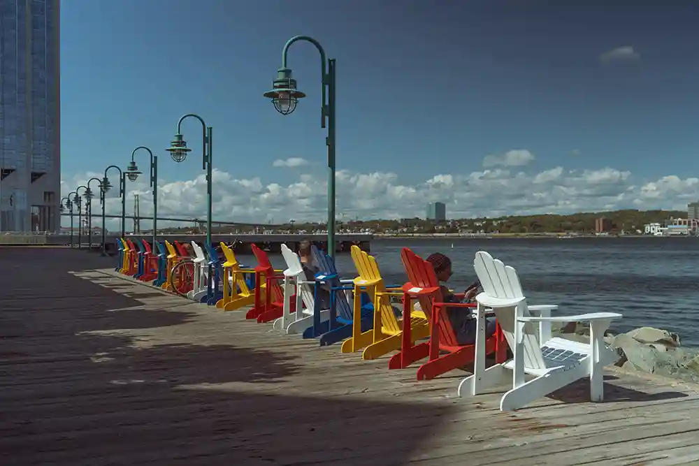 Colourful Adirondack chairs line the Halifax Boardwalk.