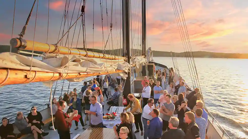 A private function on the Tall Ship Silva. People talk, enjoy beverages and food while sailing the Halifax Harbour.
