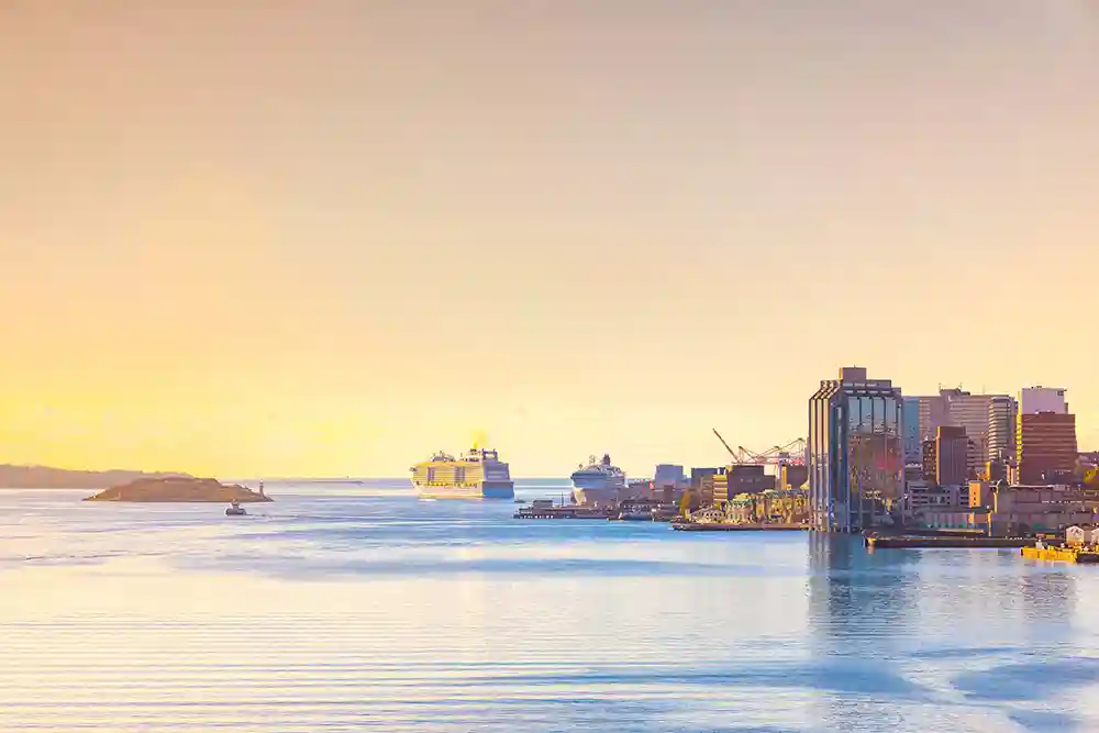 A cruise ship departs Halifax during sunset.