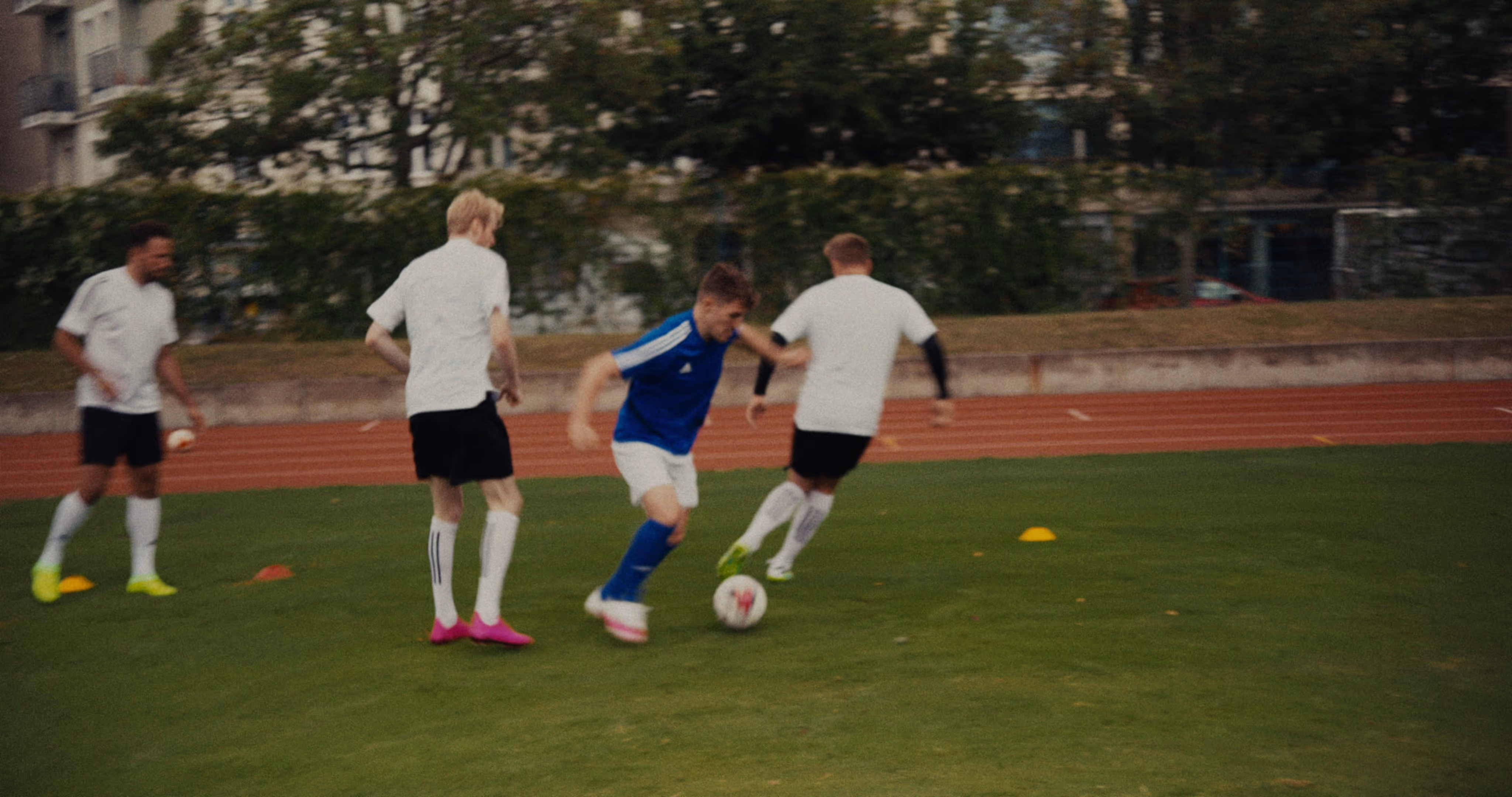A football player dribbles past multiple opponents.