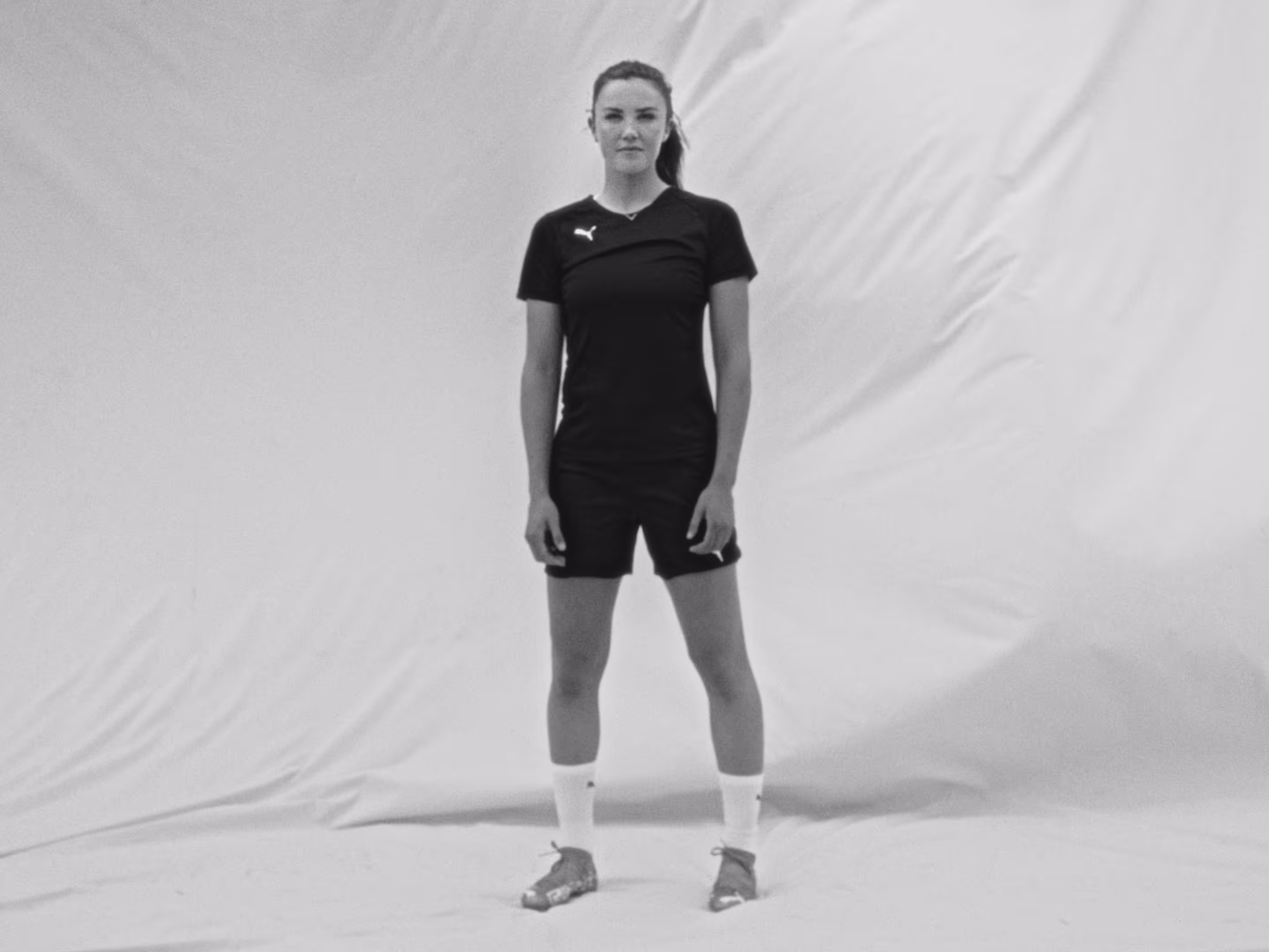 FC Barcelona player Ingrid Syrstad Engen stands in front of a white backdrop.