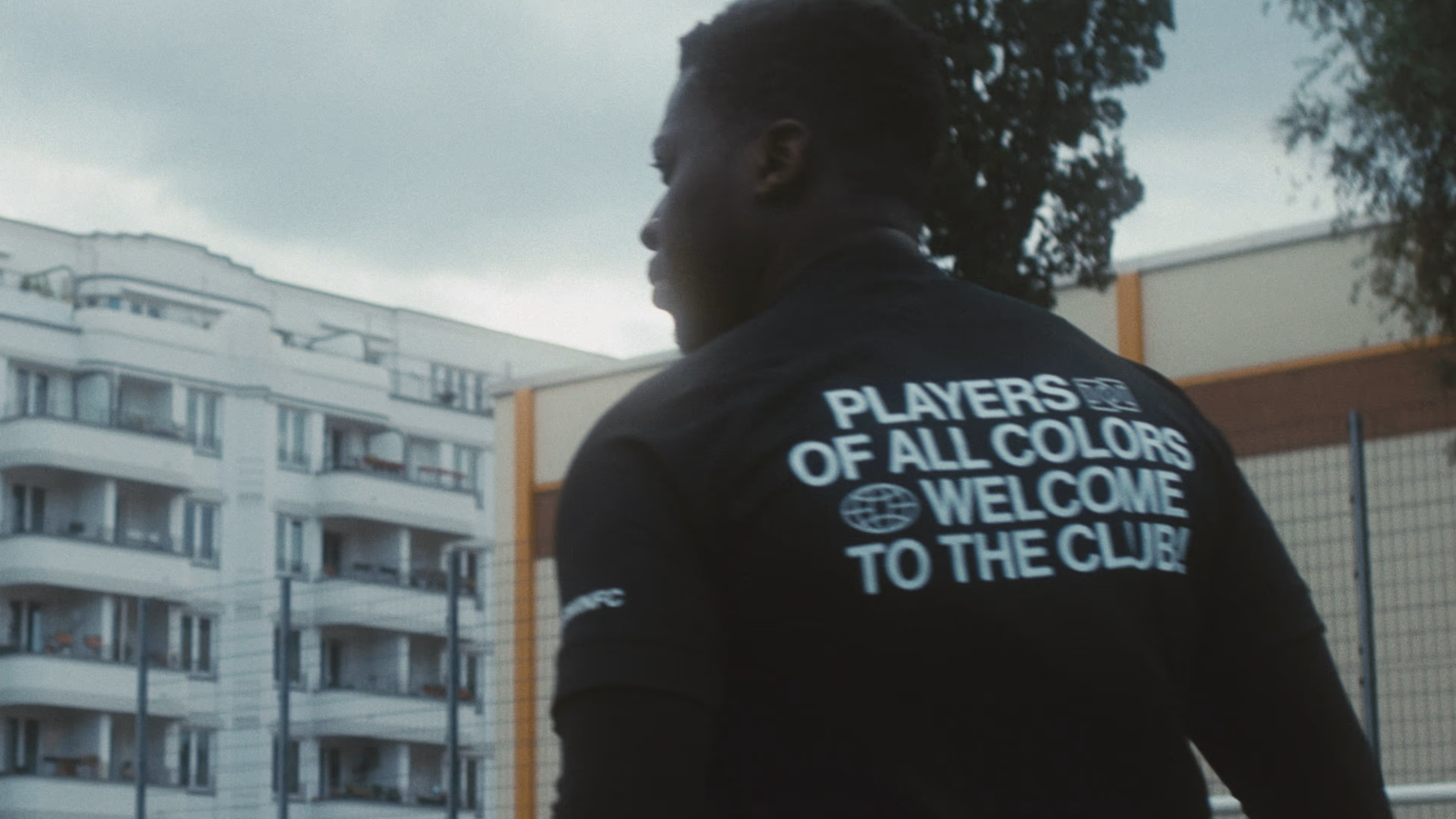 A young man looks at a football goal.