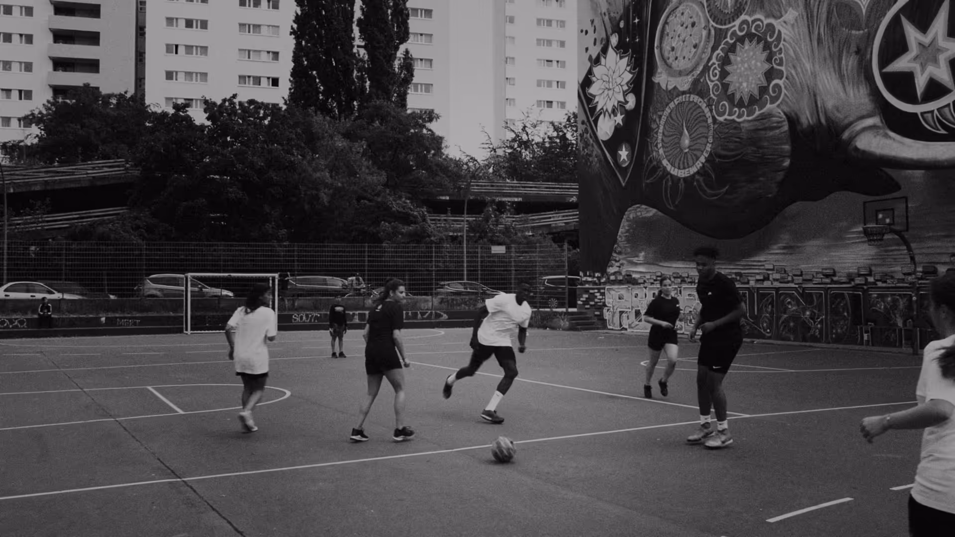 A group of young people play football together in Kreuzberg, Berlin.