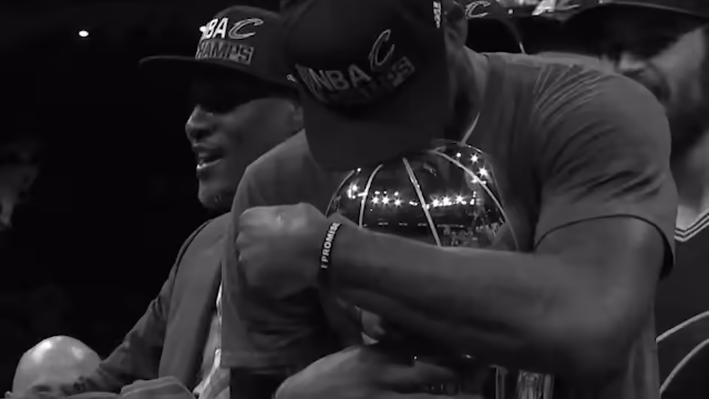 Lebron James hugs the Vince Lombardi Trophy.