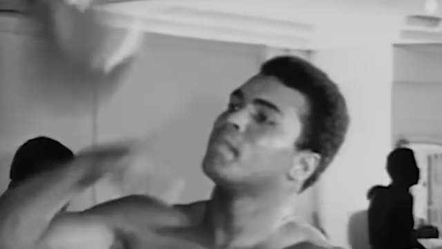 Muhammad Ali punches against a sandbag.