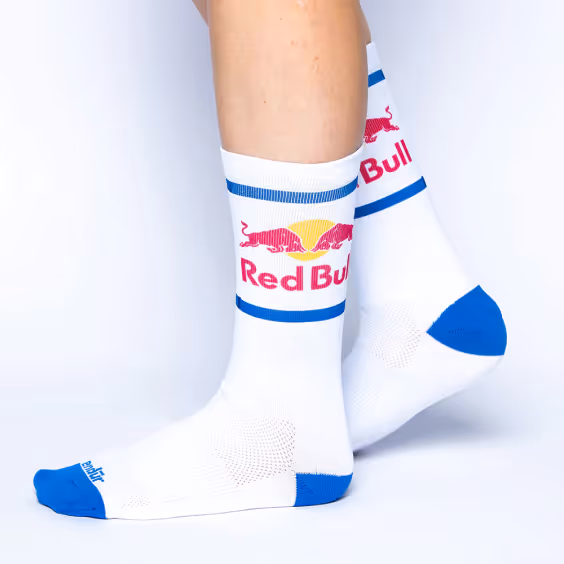 a pair of white calf socks with the Red Bull logo on them