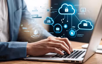 Person typing on a laptop with digital cloud security icons and network connections overlay.