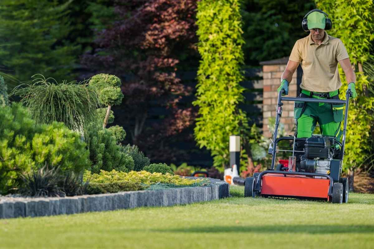 Worker performing outdoor landscape maintenance task