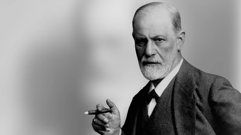 Sigmund Freud em retrato em preto e branco, com a mão segurando um cigarro