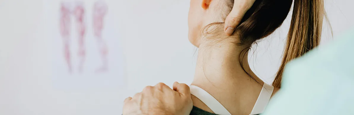 Detailed of a chiropractor hands stretching the neck of a woman