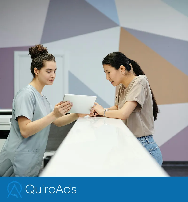 Receptionist giving an appointment to a woman in a clinic
