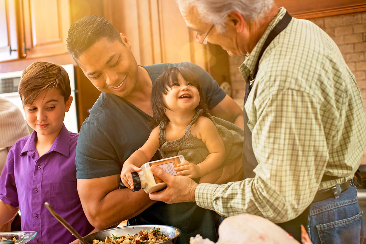 Mixed ethnicity family having fun cooking in the kitchen