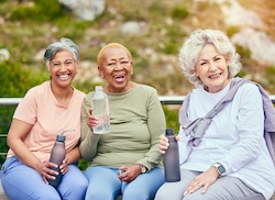 Group of people drinking water on a bench