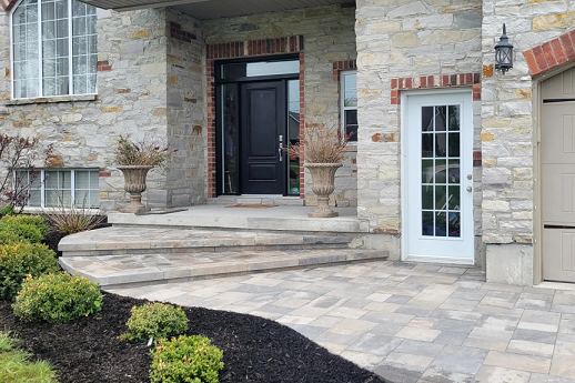 Light toned stone walkway with stone steps and curved edge