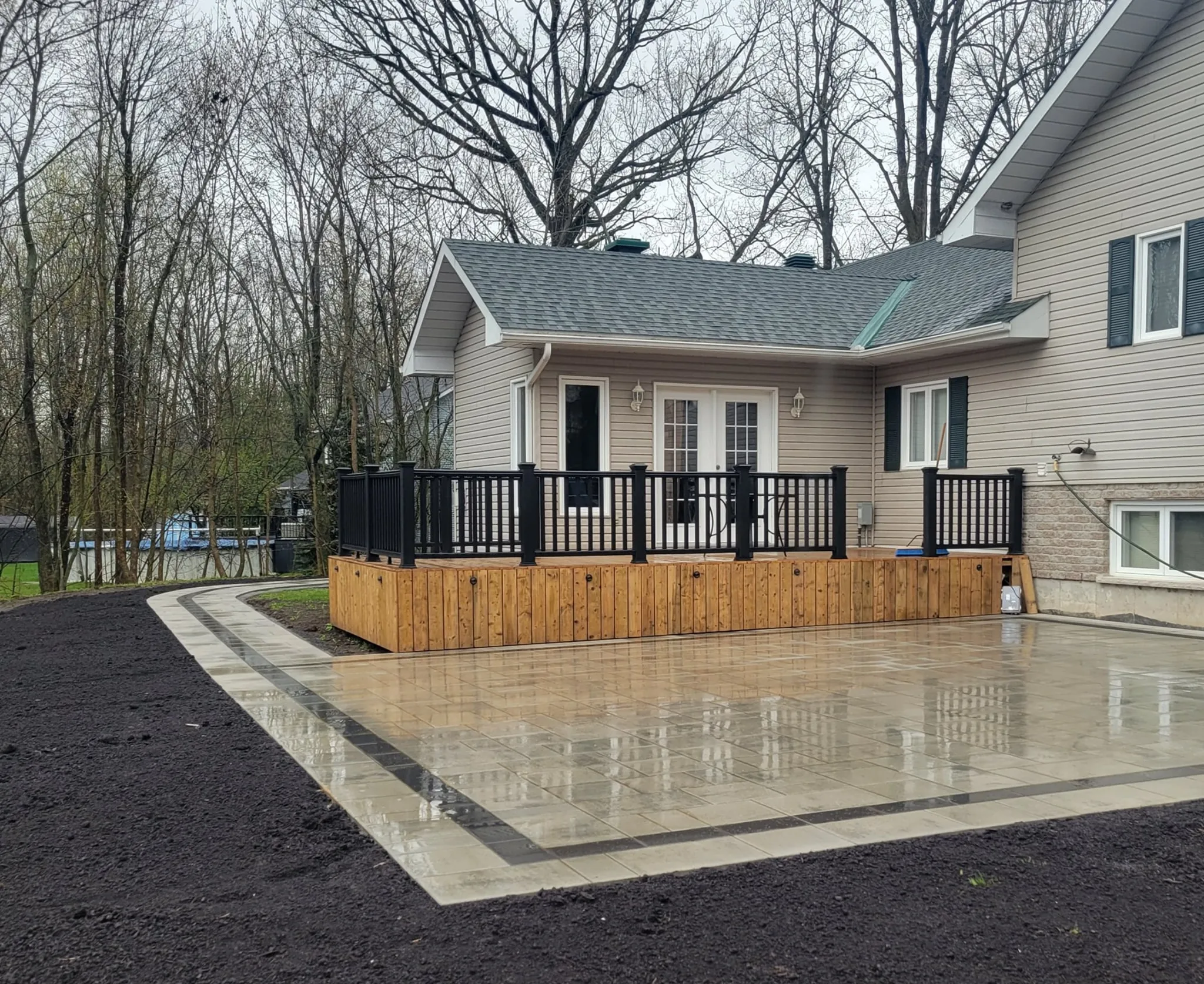 Large back stone patio with deck