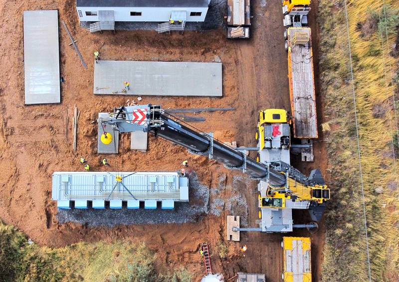 Data center container being craned into position at project site