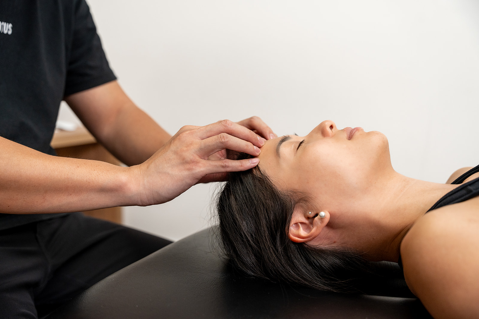 A woman getting a head massage at a salon