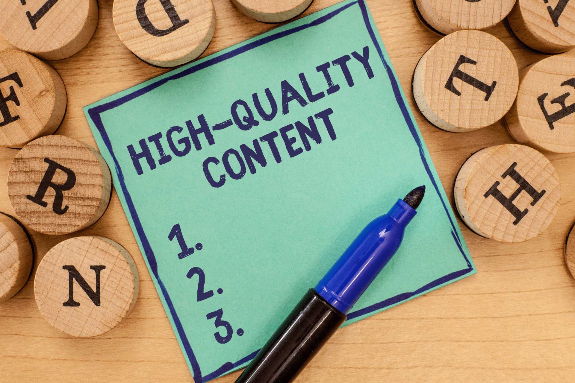 A square note with the text ‘High-quality content’ and a numbered list; surrounded by wooden letters