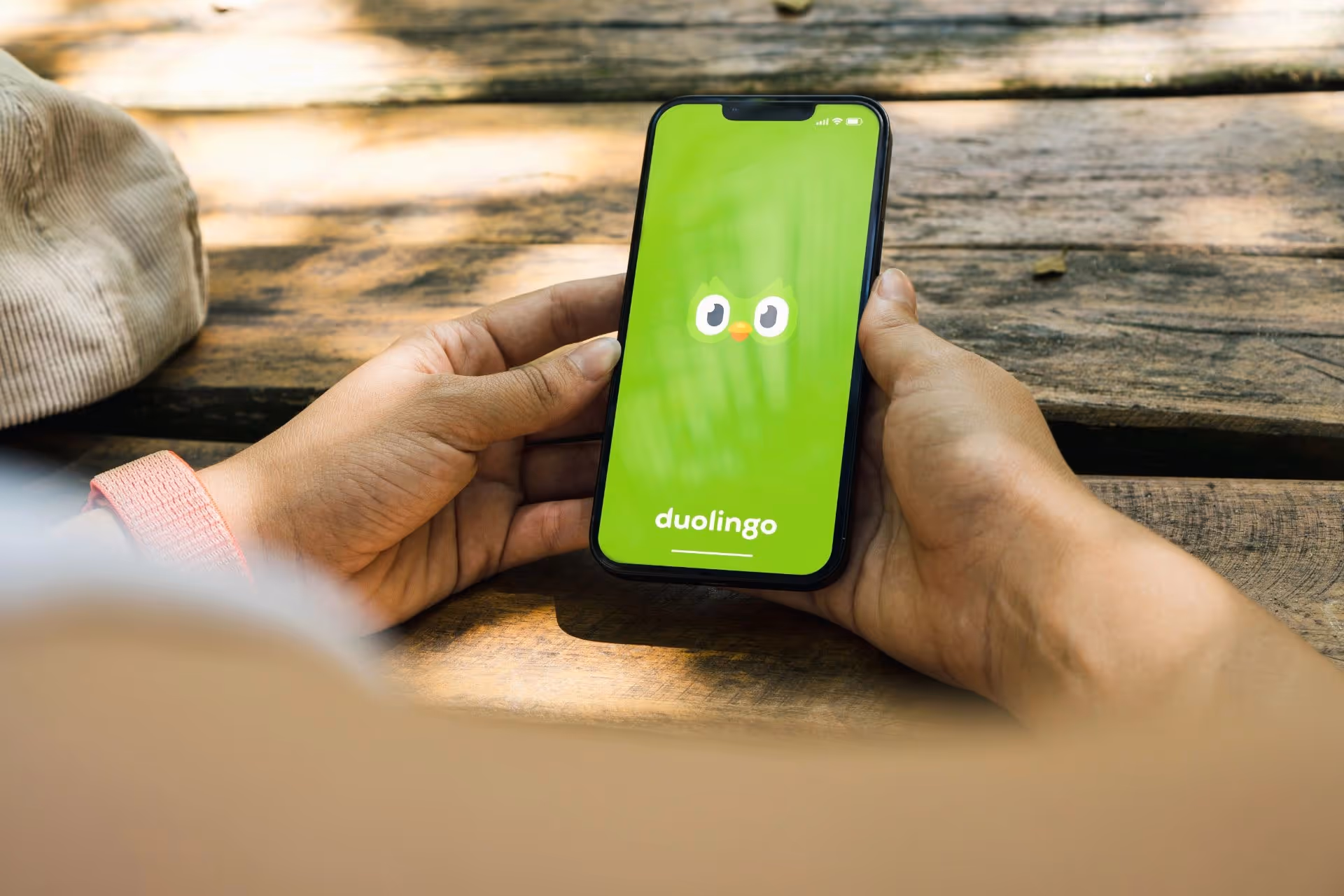 A person opening the Duolingo app on their phone