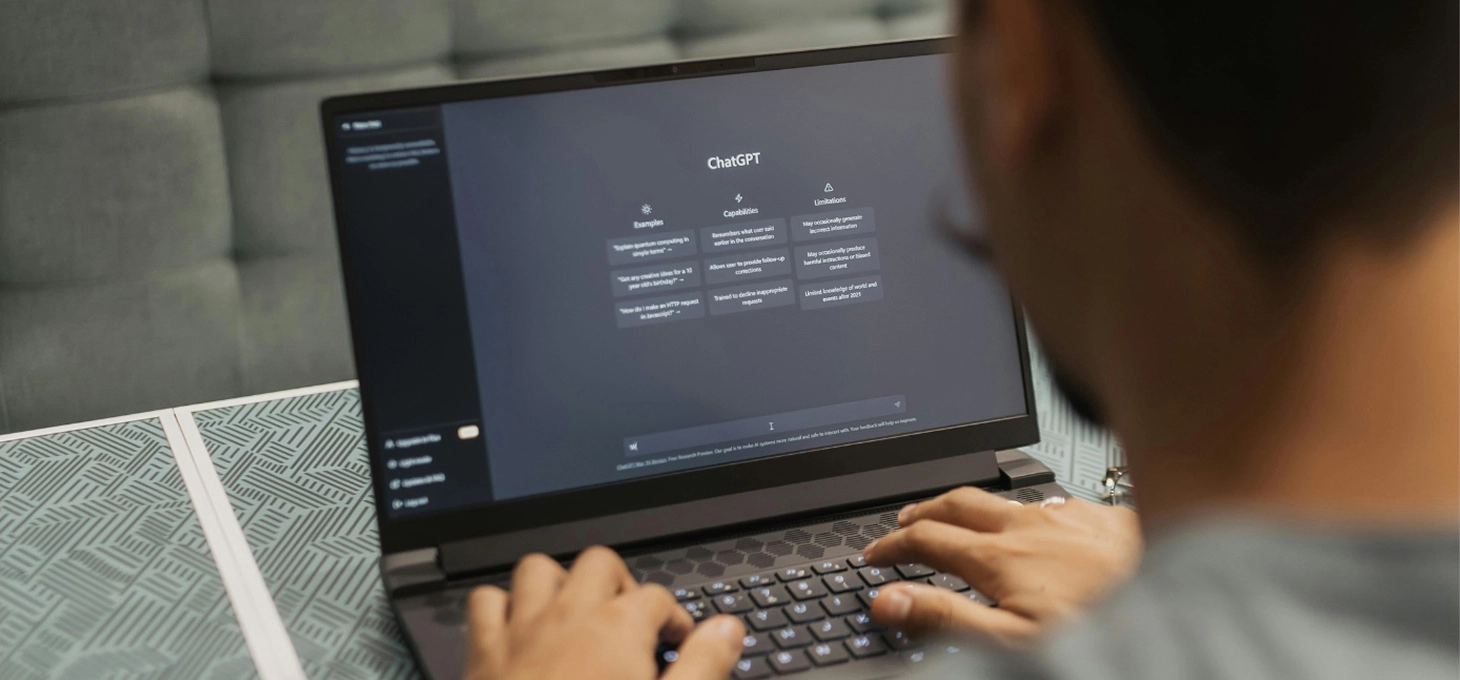 Person using ChatGPT on a laptop to generate content, illustrating AI-powered blog writing and SEO productivity tools.