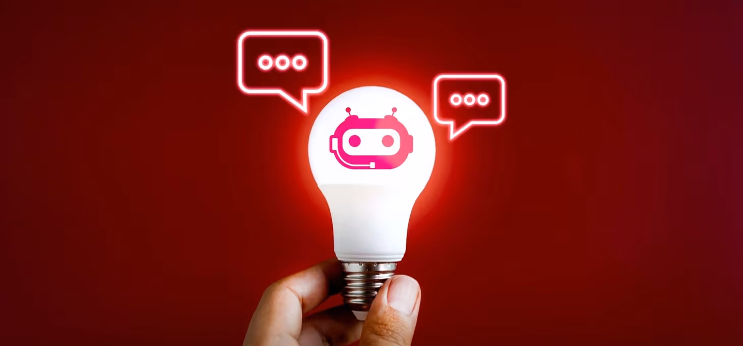 A glowing lightbulb features a robot head outlined in red at its center, illuminated brightly. On either side, two chat boxes hover, completing the scene.