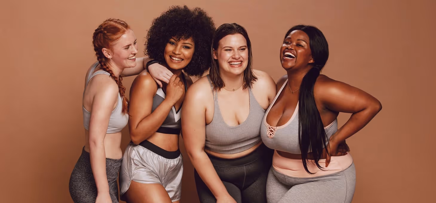  Four women smiling and posing for the camera