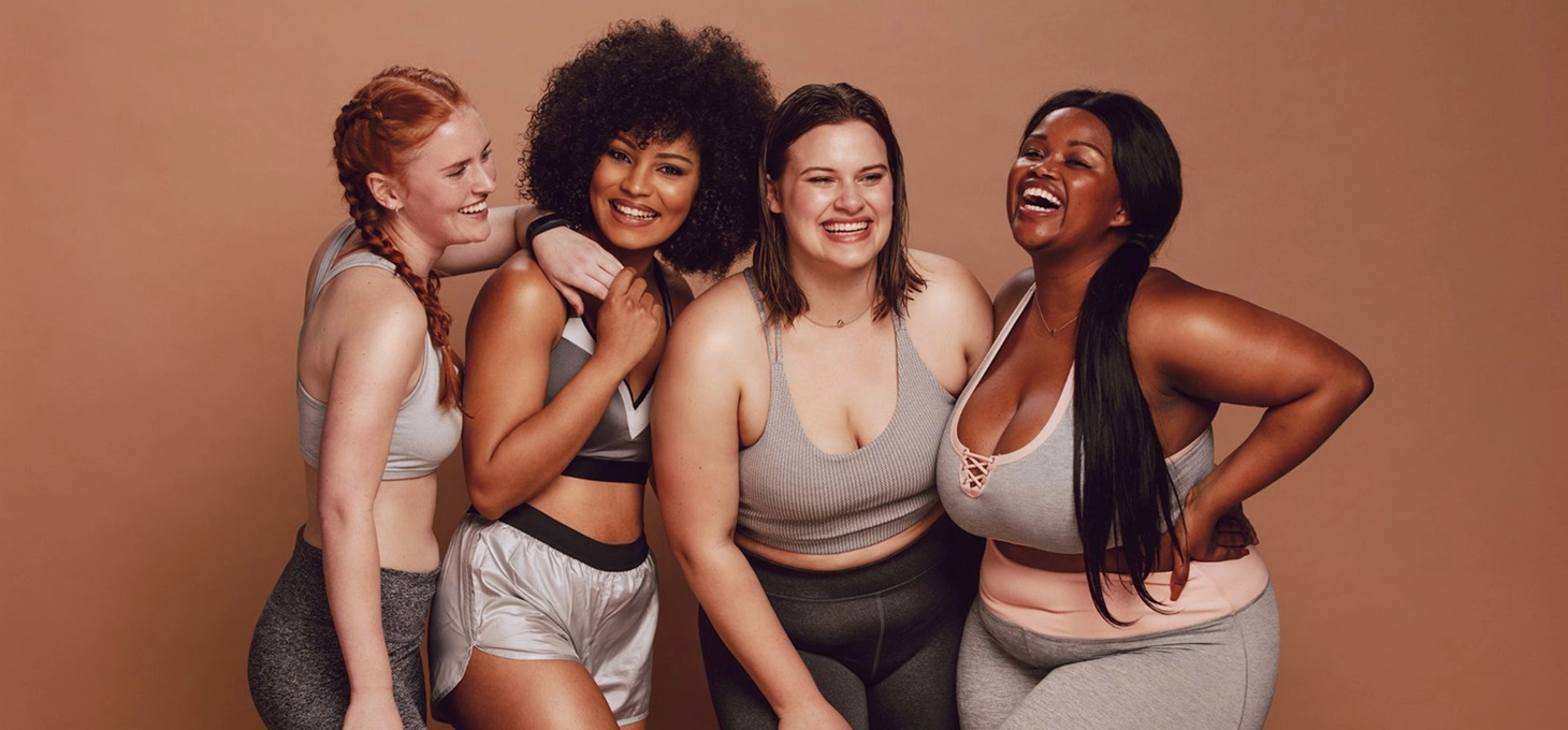  Four women smiling and posing for the camera