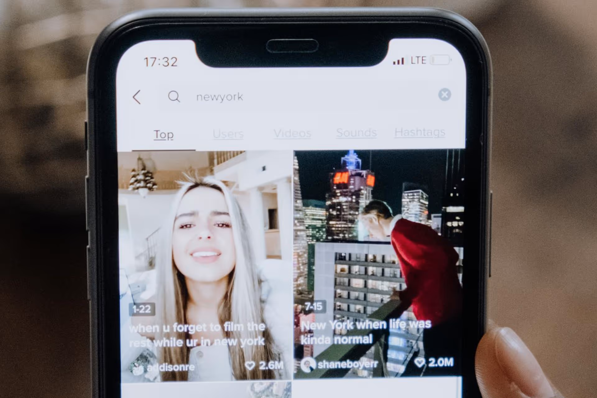Scrolling TikTok posts on an iPhone