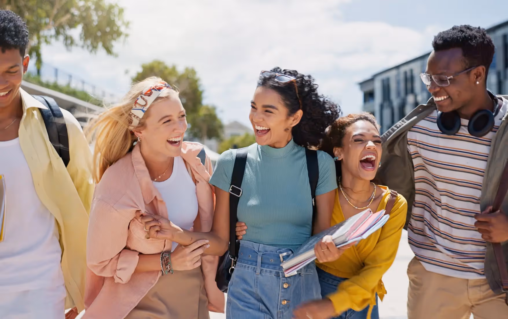University students walking and laughing on campus.