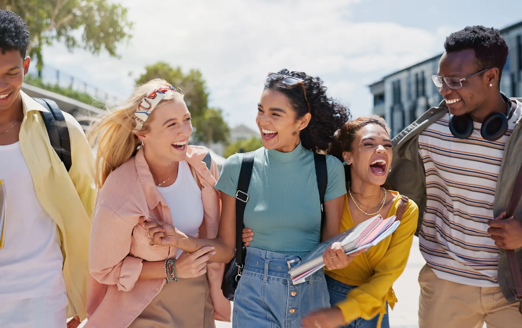 University students walking and laughing on campus.