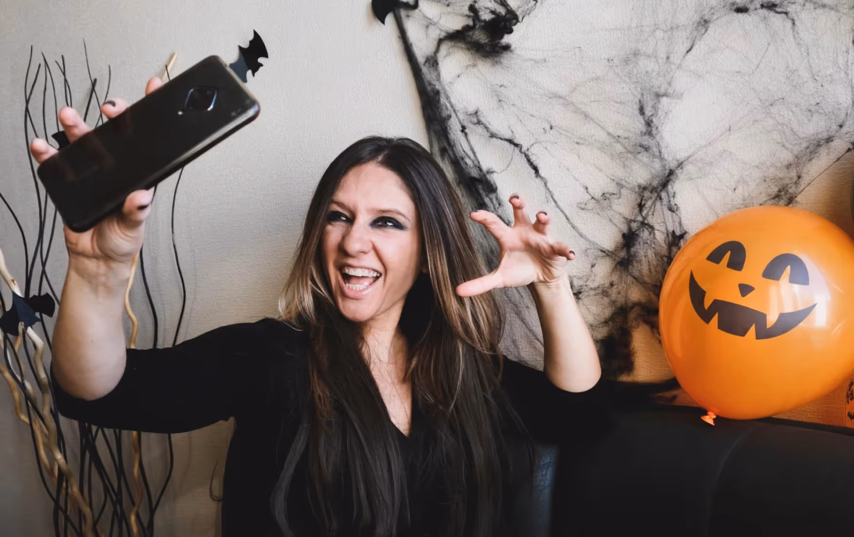 Halloween TikTok creator making a scary face while taking a selfie