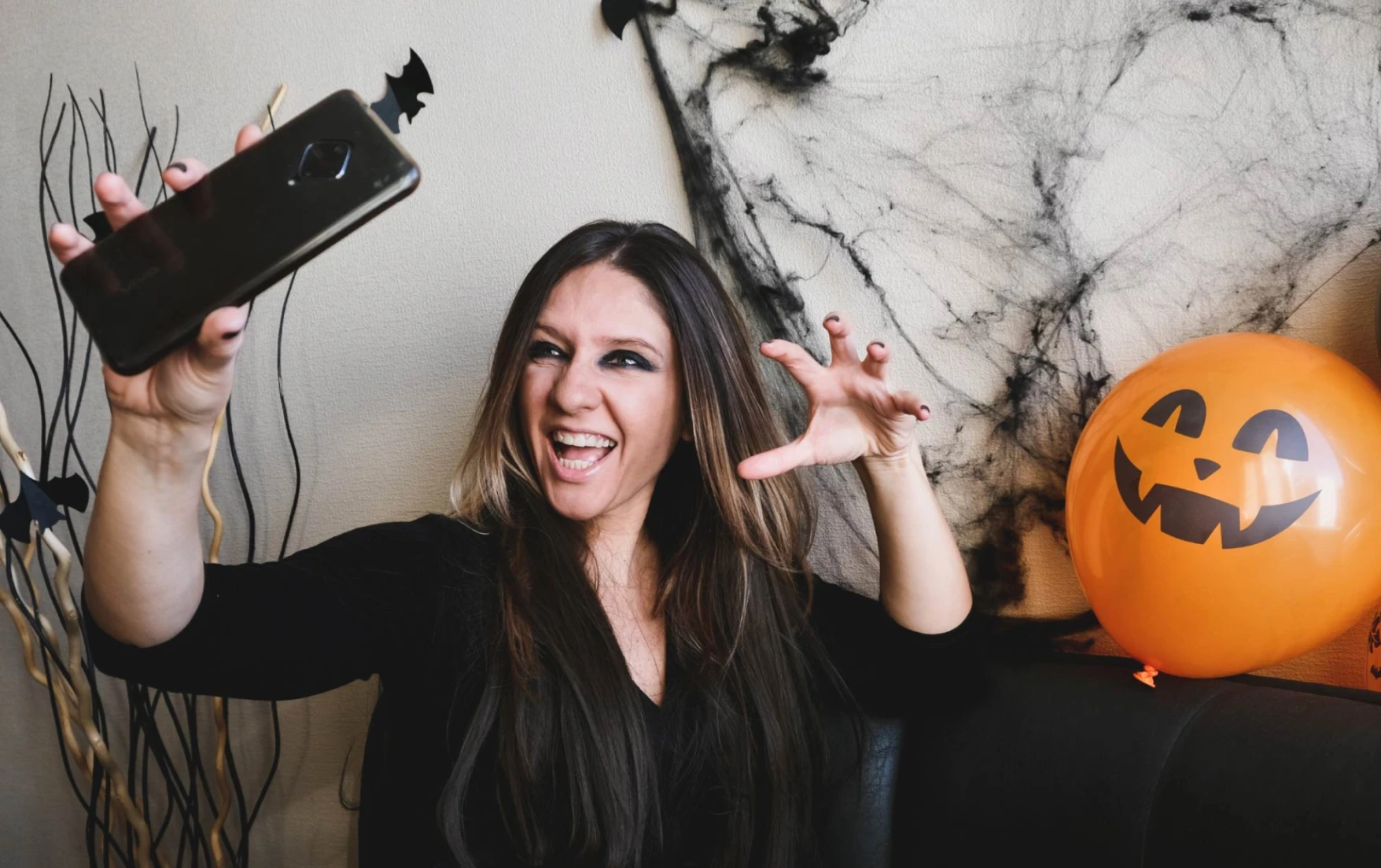 Halloween TikTok creator making a scary face while taking a selfie