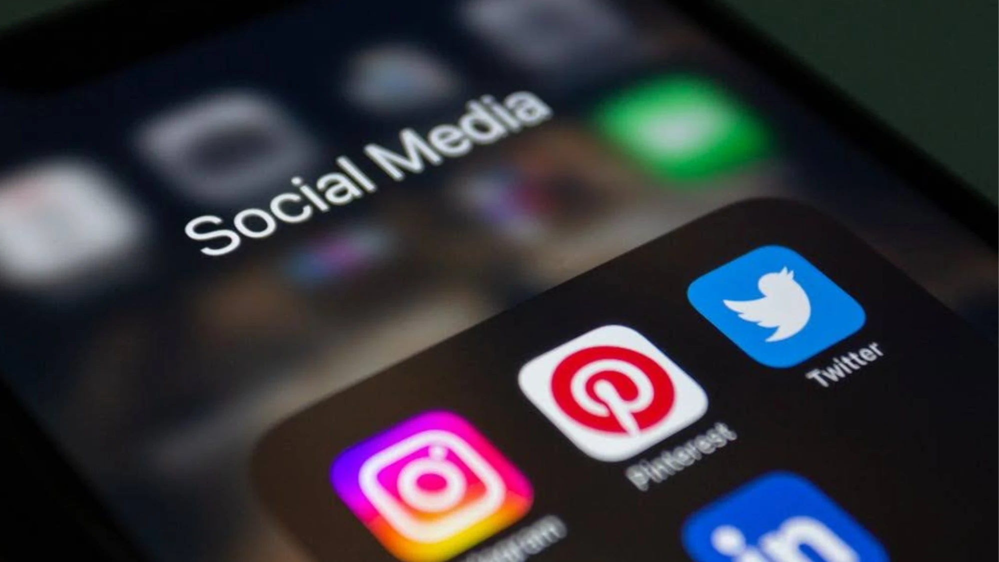 Smartphone screen showing social media app icons, including Instagram, Pinterest, Twitter, and LinkedIn