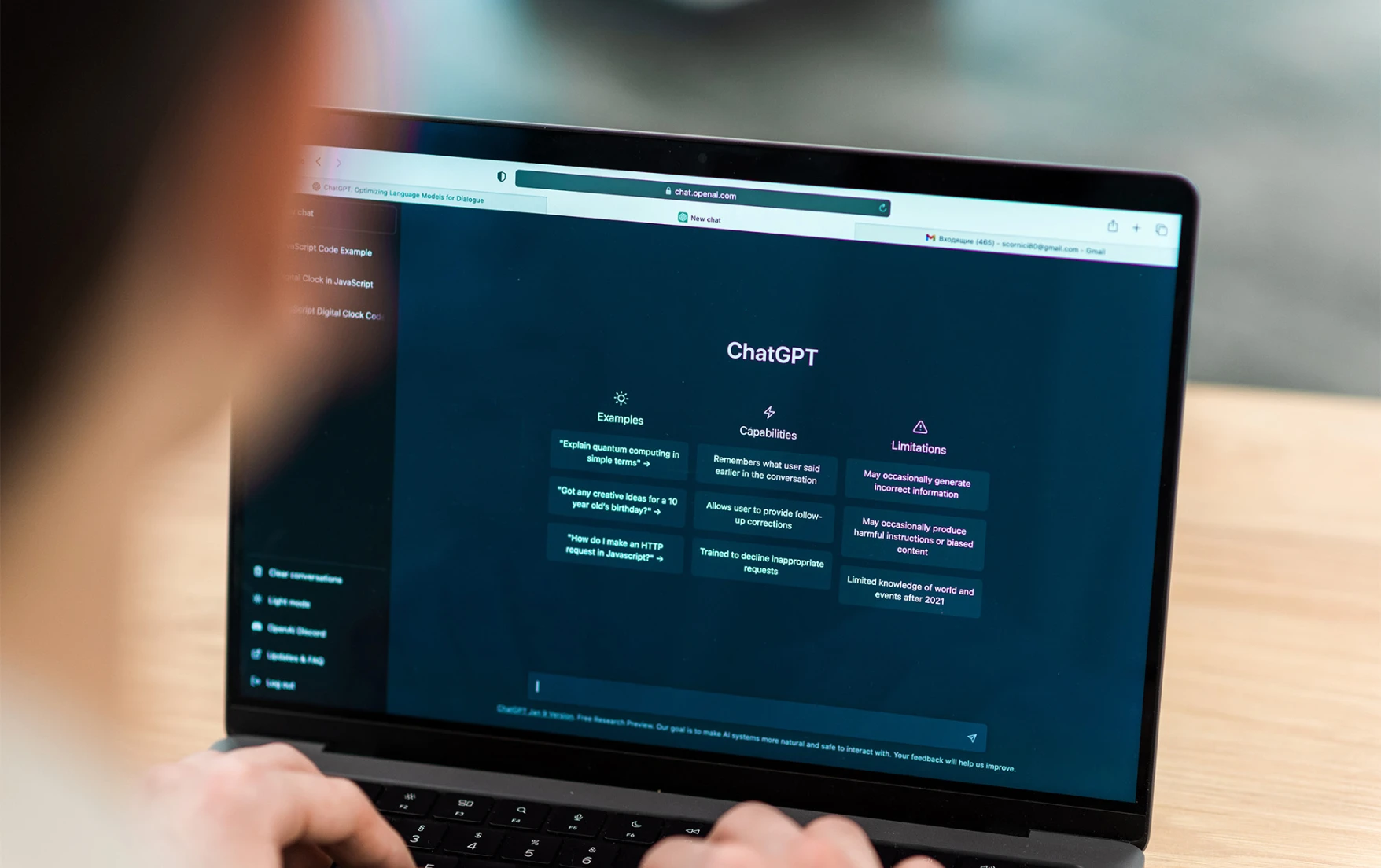 A person using a laptop enters a prompt into ChatGPT.