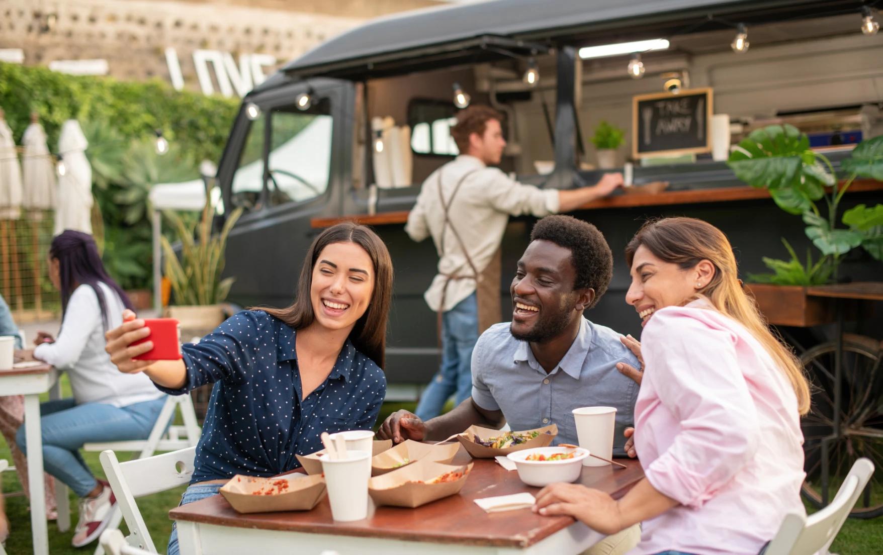 A group of influencers taking a photo at a food truck park