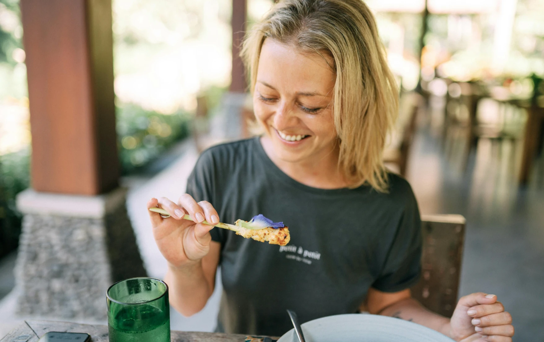 A woman eating at a vegan restaurant