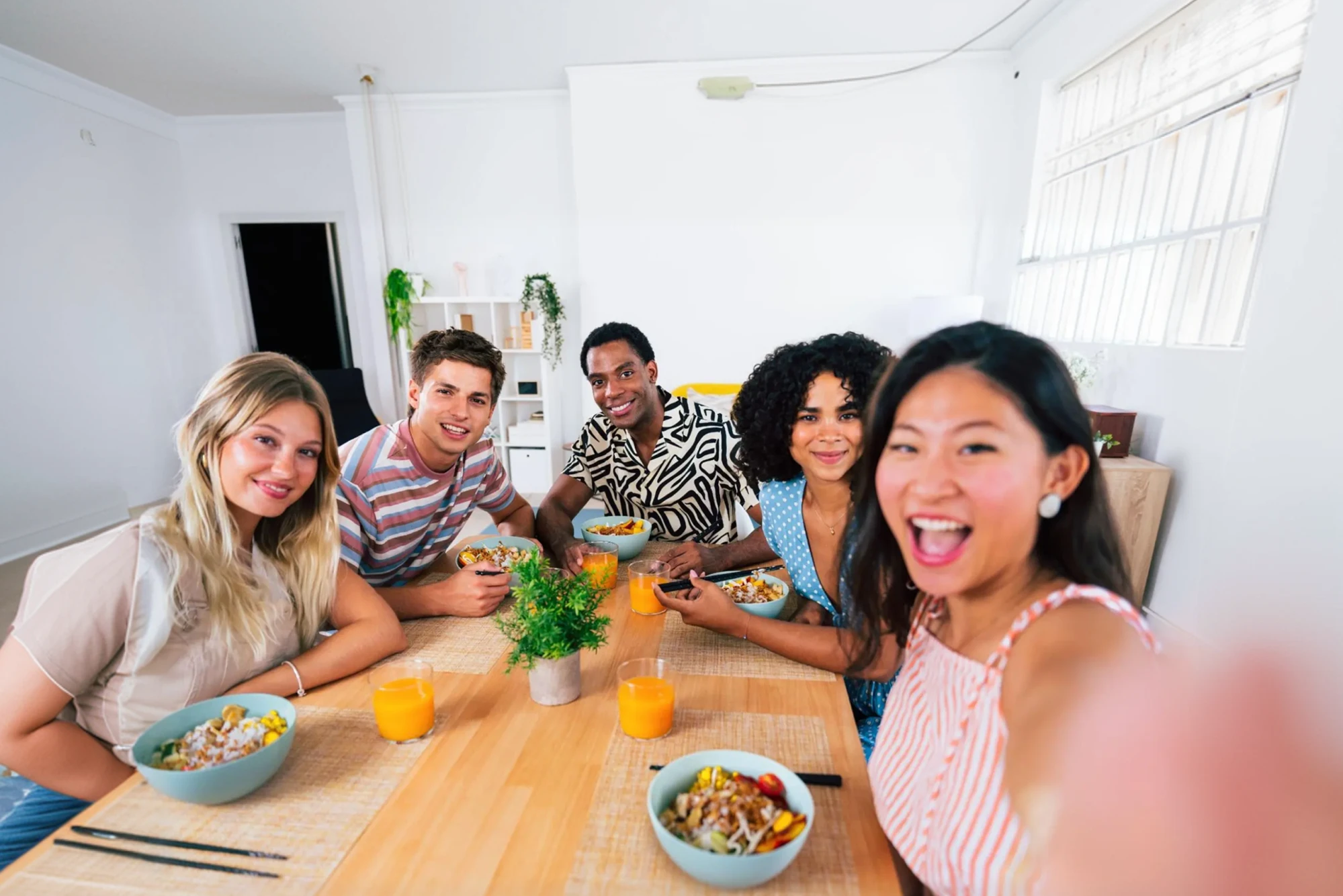 A group of millennials take a selfie over brunch.