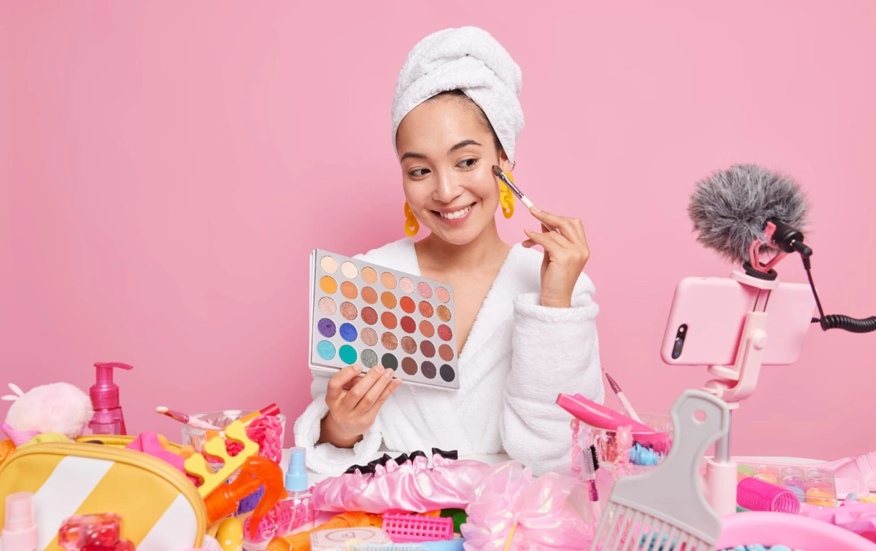 Influencer showing makeup products during a livestream/recording