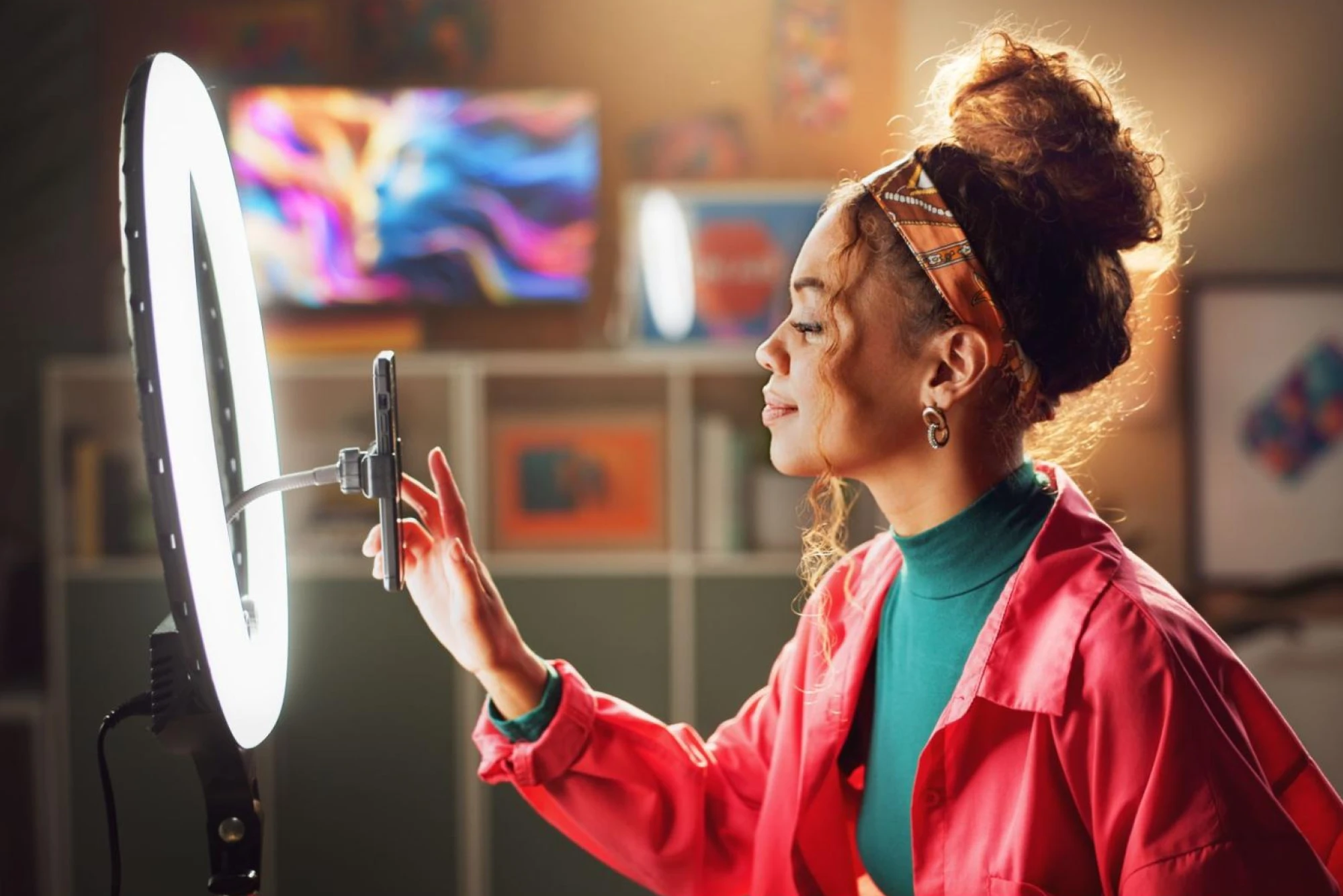 A female influencer with a phone and a ring light for video recording.