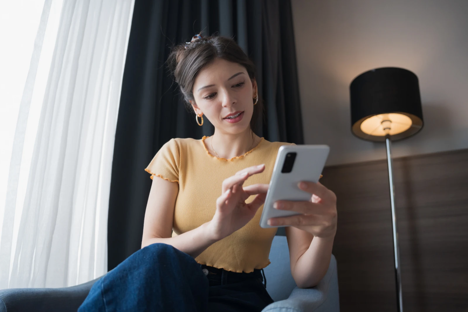 A Gen Z woman scrolling through her phone
