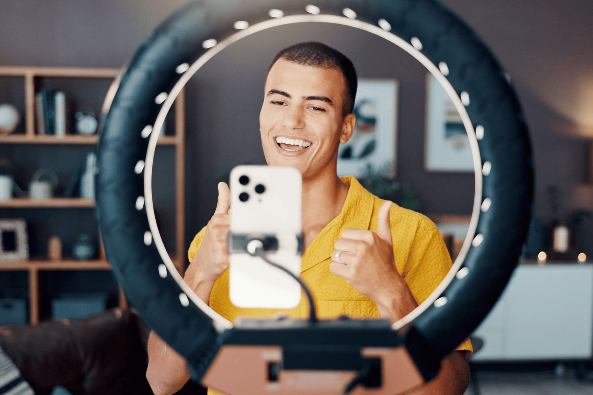 Male fashion influencer shooting social media content with a phone and ringlight