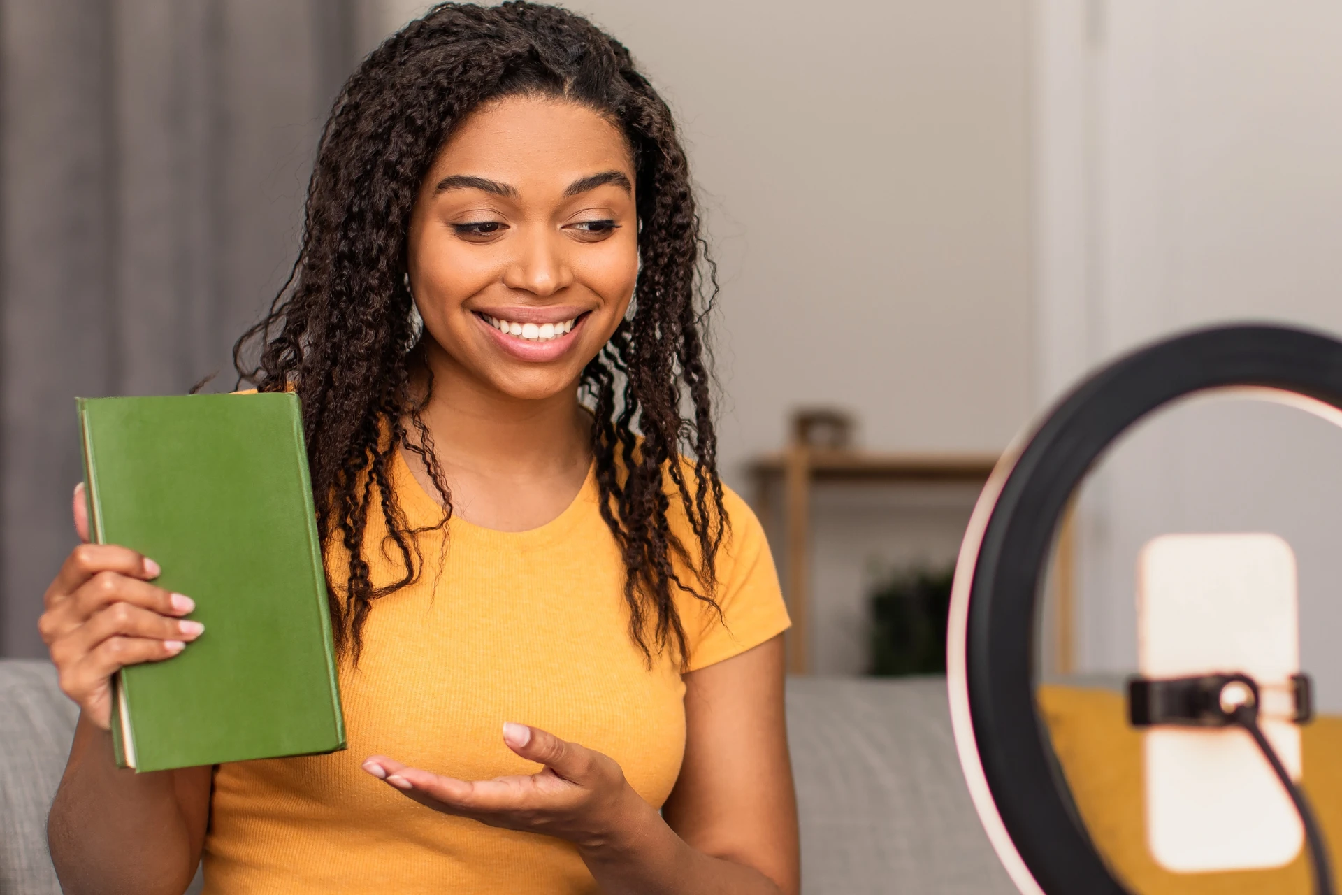 Booktok influencer recording content on her phone