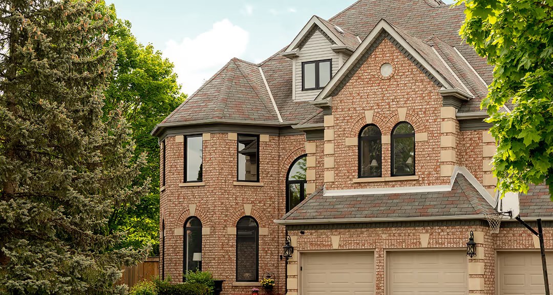 Brick home exterior with black-framed Clera windows