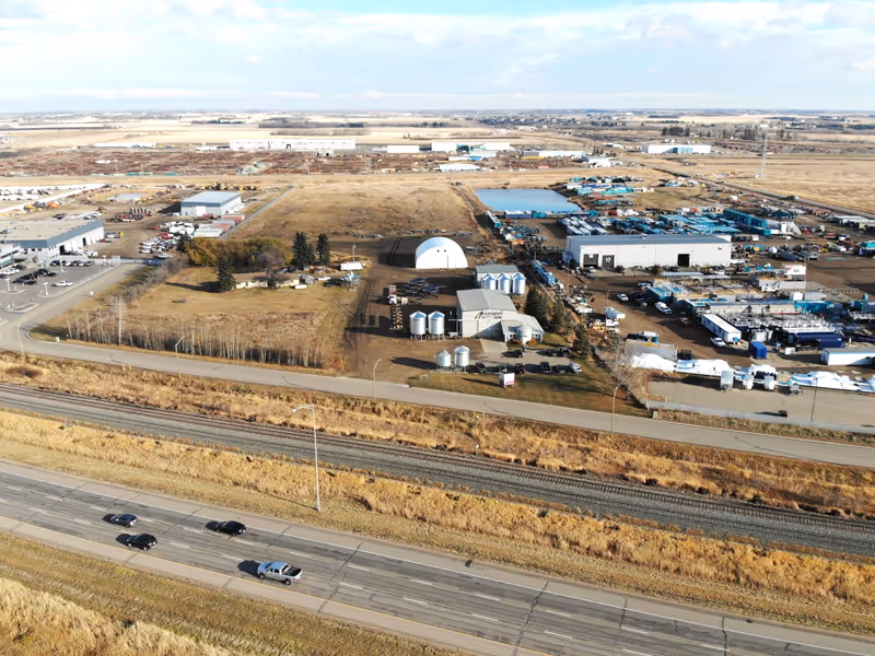 An aerial view of a large farm and a highway