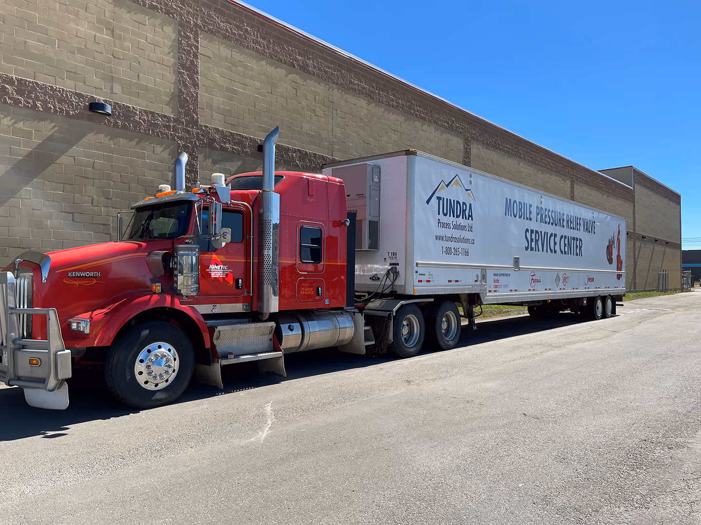 A red truck parked in front of a building