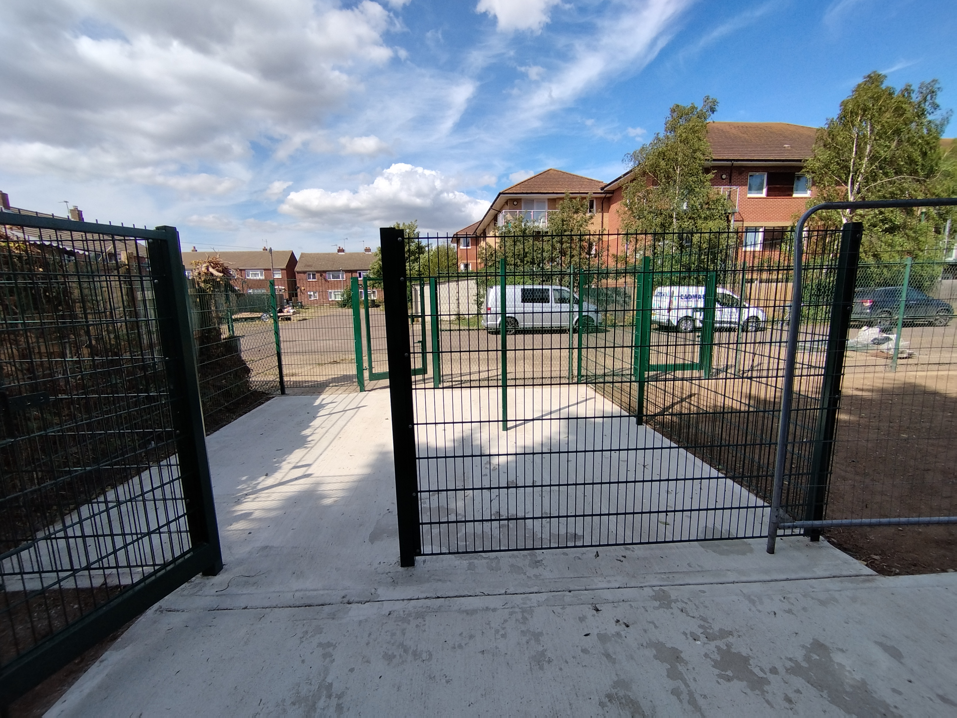  fenced off bin area with Euro bins and recycling
