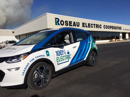 Electric vehicle outside Roseau Electric Cooperative